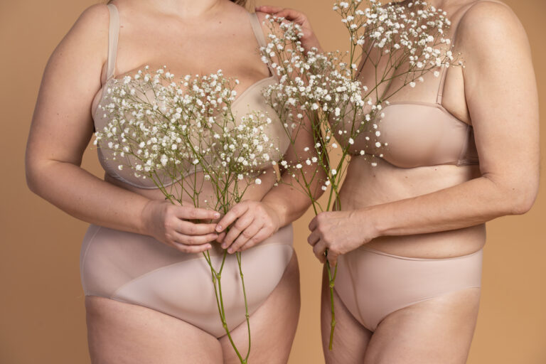 Deux femmes l'une à côté de l'autre en sous vêtements couleur chaire avec des fleurs blanches